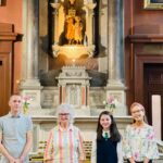 Graphic of four people standing at the altar getting their photo taken. They are smiling at the camera.