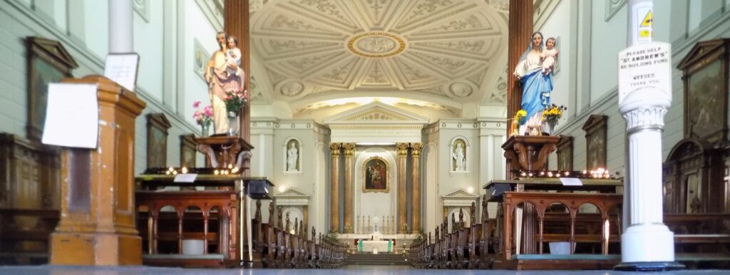 Graphic of the inside of St. Andrew's Church, Westland Row which shows two statues to either side of the benches for the congregation and the altar.