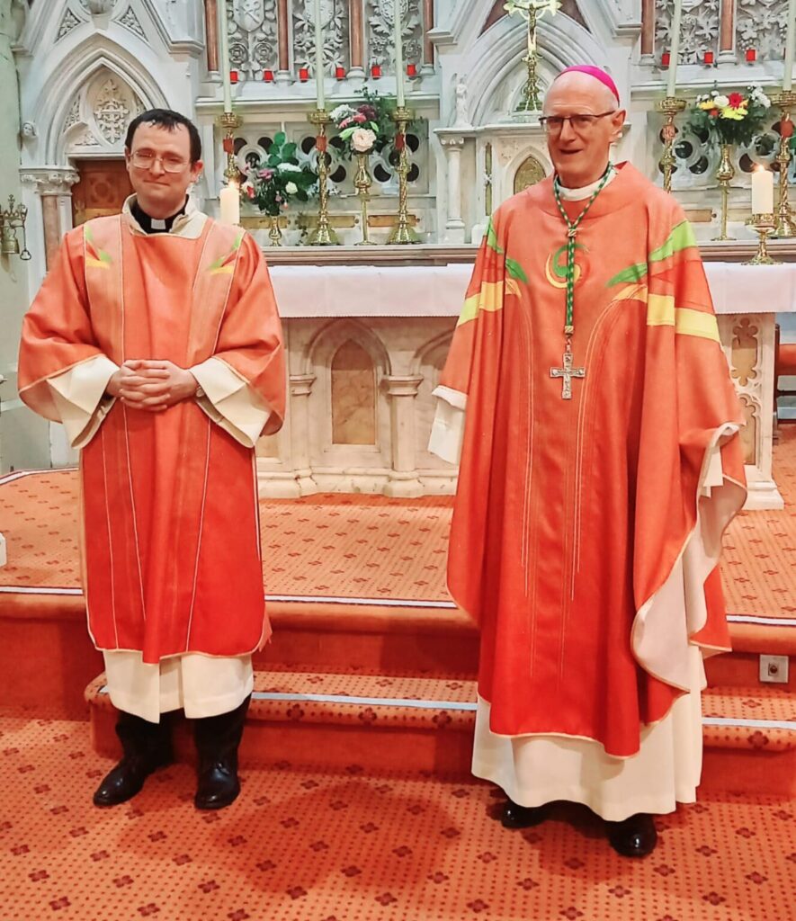 Graphic of Archbishop Dermot Farrell with newly ordained Joseph Keegan in their red robes at the altar.