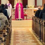 Graphic of two priests in purple and white robes standing at the altar talking to the congregation.