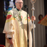 Graphic of newly appointed Archbishop Dermot Farrell speaking to the congregation in his new gown.