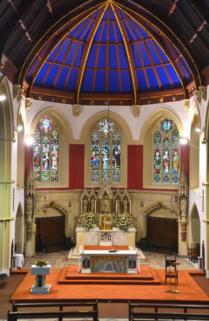 Mass for Deceased Members of An Garda Síochána – Homily of Archbishop Dermot Farrell. Graphic shows the inside of a church including the altar and the stained glass windows.