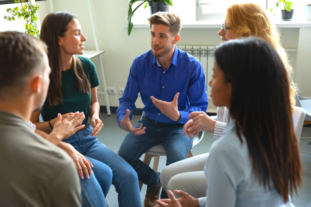 Building Hope parish gathering resources. Graphic depicts a group of people talking to each other and brainstorming ideas surrounded by plants and a shelf, window and radiator.