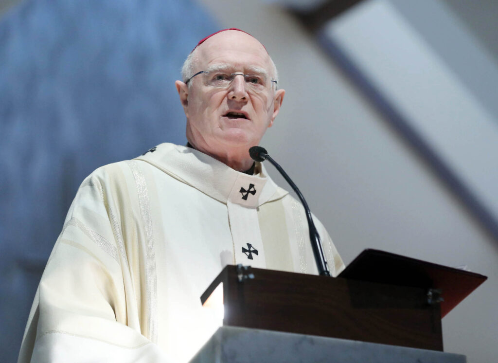 Graphic of Archbishop Farrell addressing the congregation from a stand on the altar wearing a white robe and pink skullcap.