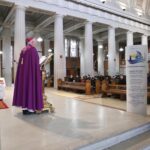 Graphic of a priest in a purple robe with a purple hat speaking to the congregation from the altar.