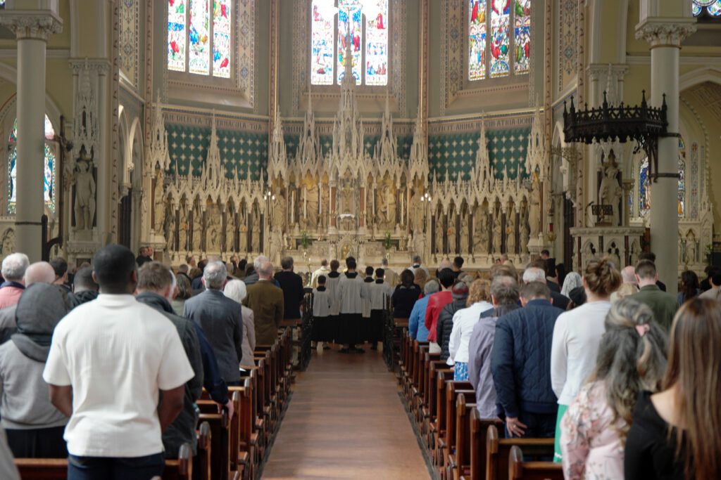 Graphic of St Kevin’s, Harrington Street where the congregation and the altar boys are standing for the ordination to the diaconate of Brother Ciarán Egan.