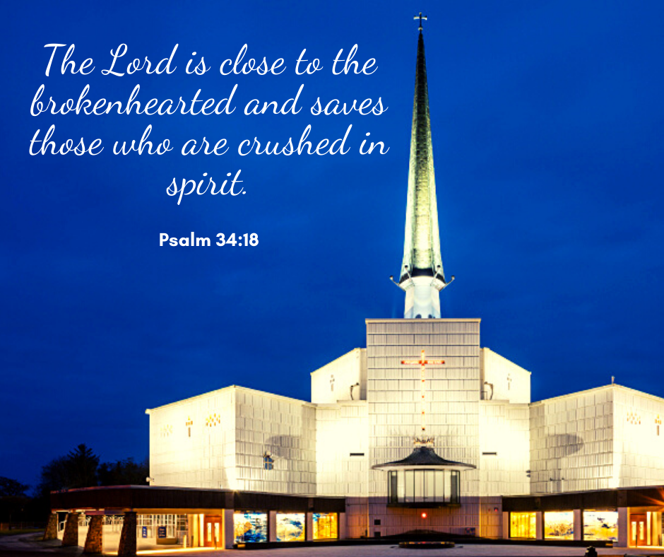 Graphic of Knock Cathedral lit up with a blue background and in the top left in white cursive writing is Psalm 34:18.