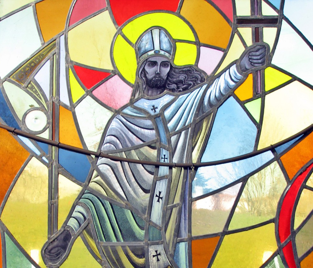 Graphic of a stained glass window depicting "Called to meet our fear", which shows a man in a white priest suit holding up a cross.