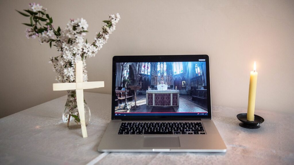 Graphic of a computer accessing the cameras in church. The computer is beside a candle, a cross and a vase with flowers.