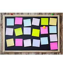 Graphic of a notice board with sticky notes stuck on it and one sticky note has an orange thumbtack in it. The notice board is on a wooden panel.