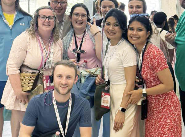 Graphic of the home page for youth and young adults under mission and ministry. Graphic shows a group of people getting their photo taken and smiling at the camera wearing lanyards around their necks.