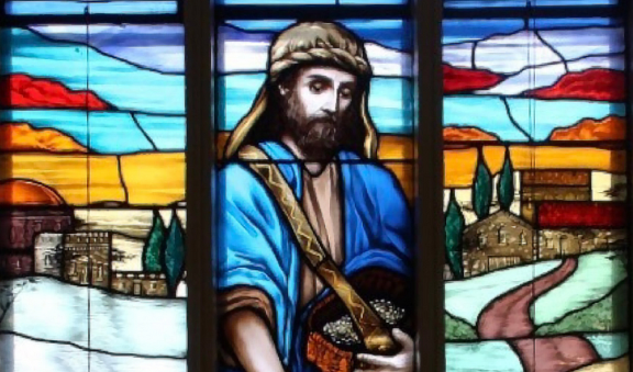 Graphic of a stained glass window for seeds of faith with a man in a blue robe spreading seeds on a path in front of a small village with colourful clouds at the top.