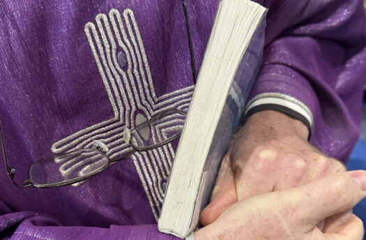 Image of a person clutching a book